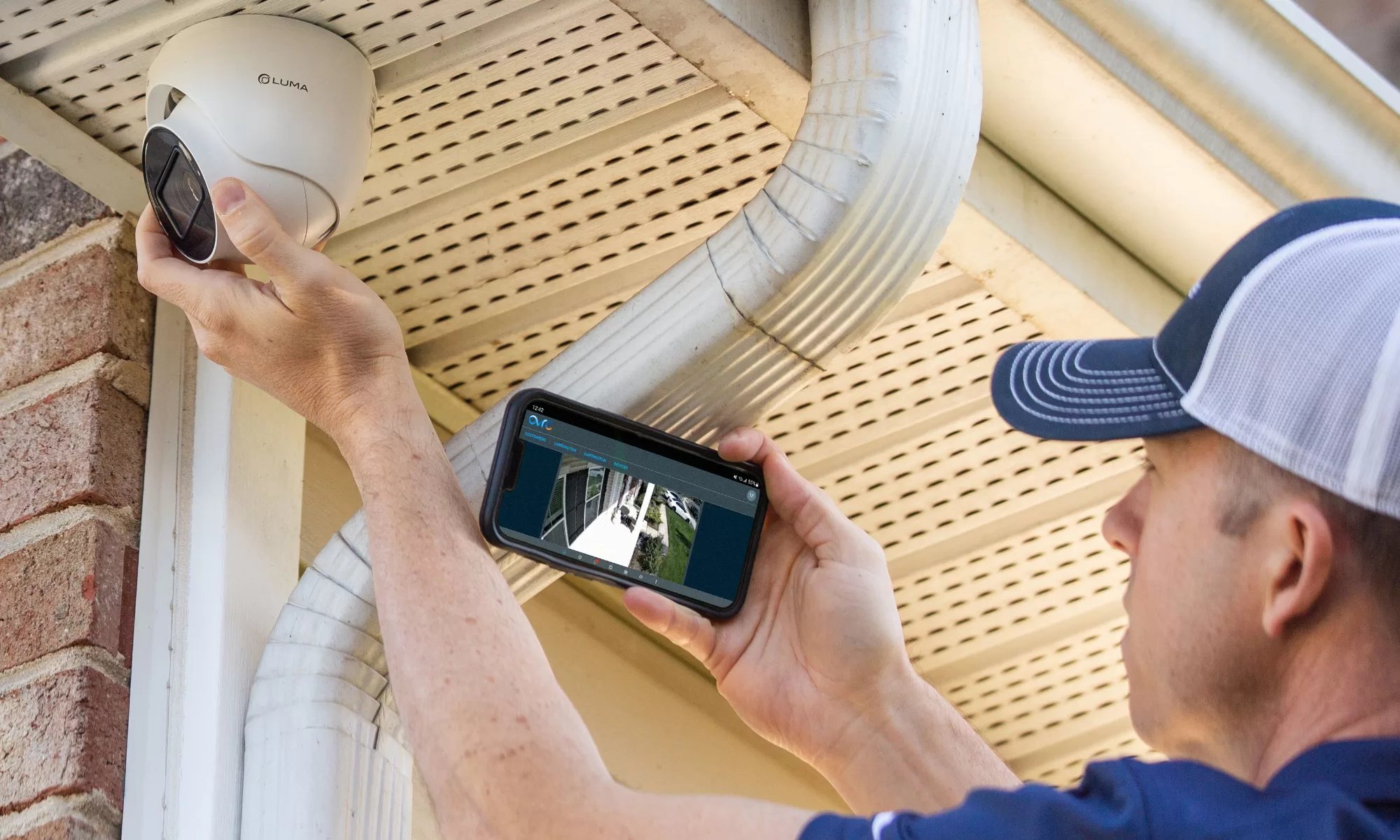 One Sound Choice technician installing government-spec 4K security camera with professional precision