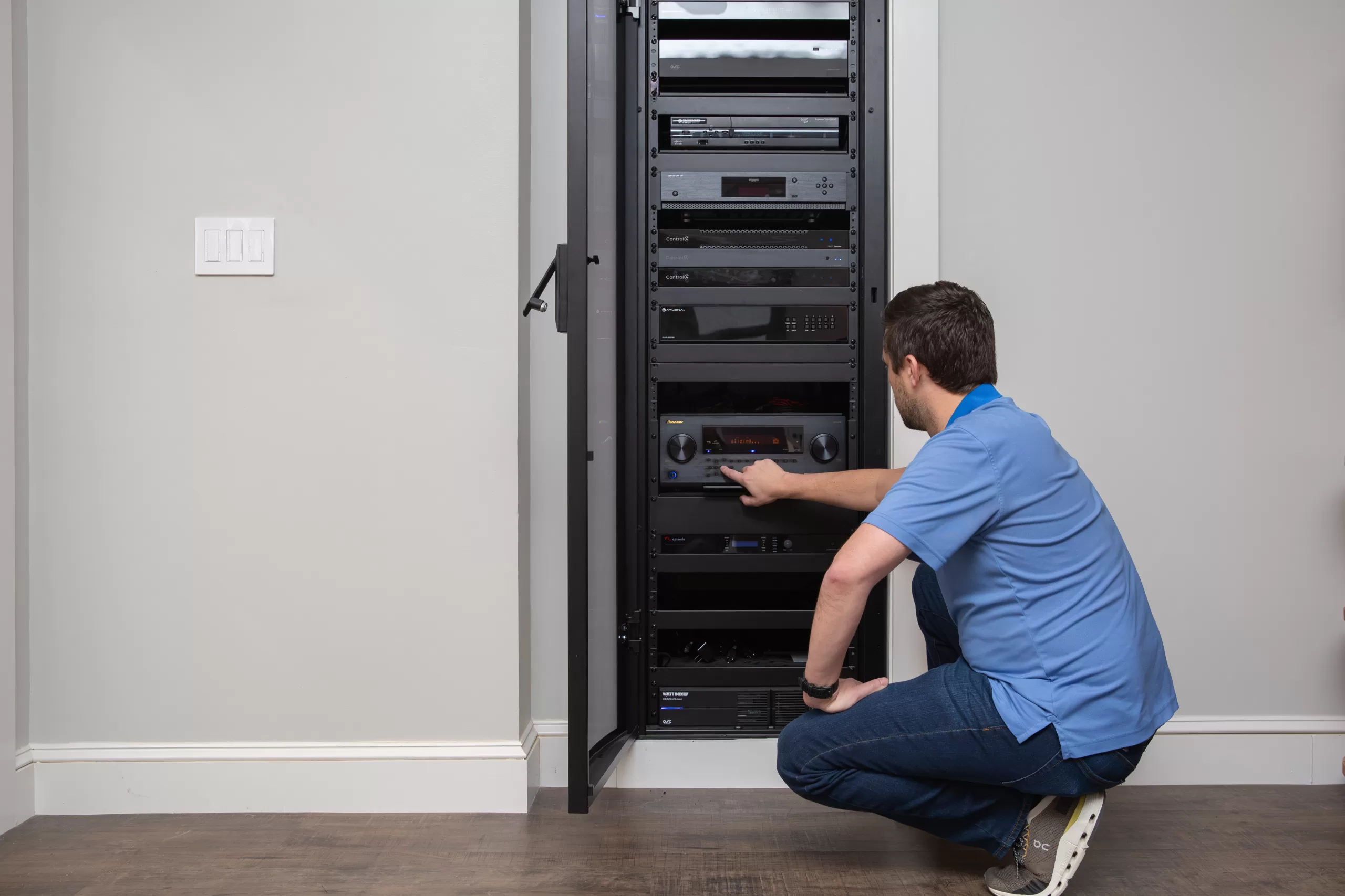 Essex County homeowner examining energy-efficient smart home equipment rack that saves $200 monthly