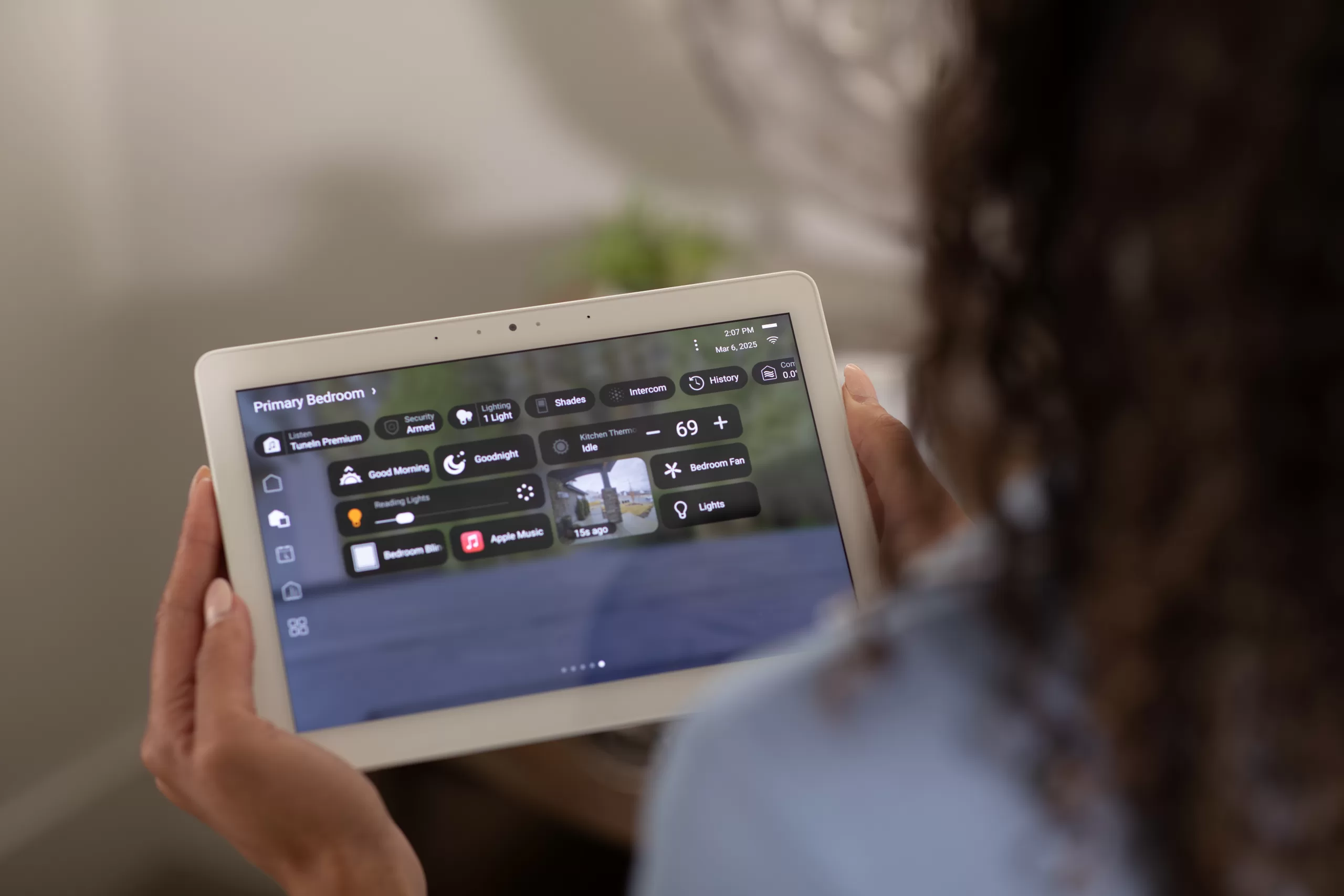Essex County mother monitoring home security system on smartphone to know when kids arrive home